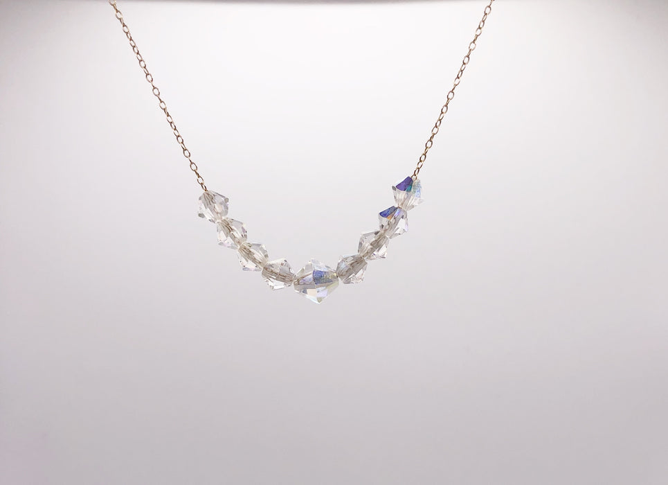 9 Rainbow Crystals strung on a fine gold chain necklace.